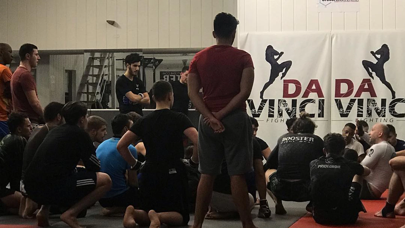 Davinci Fighting: a group briefing on the club mats before an MMA training session in Brussels.