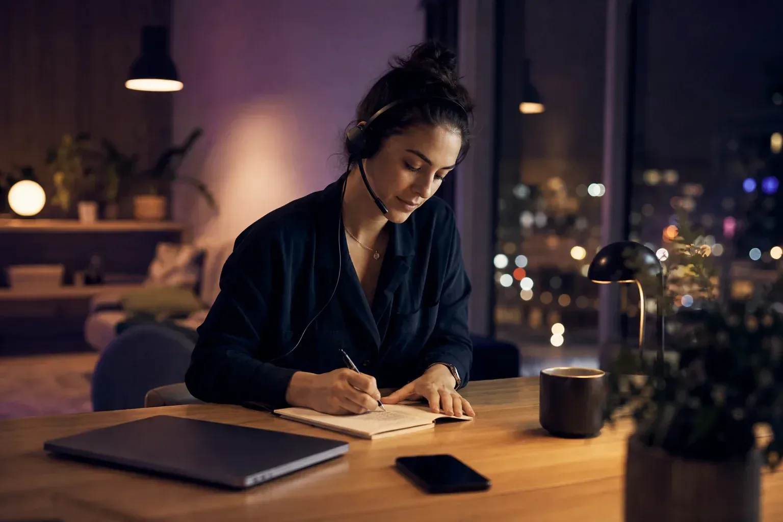 A customer support specialist supervising enquiries handled by an AI assistant in the evening